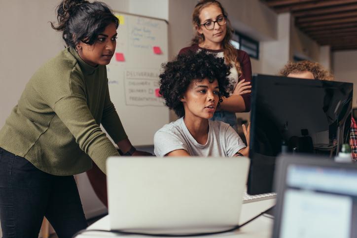 female software engineers around a computer