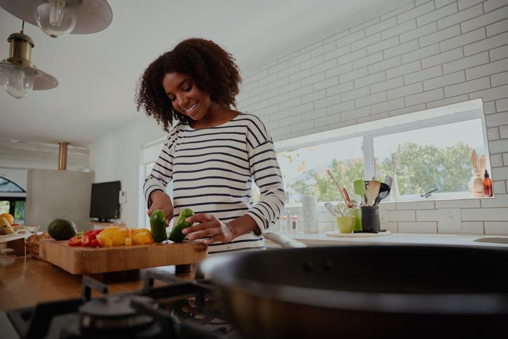 Young woman cooking in her kitchen