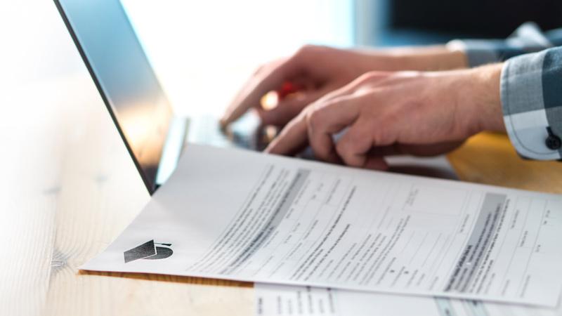 Admissions officer reviewing DET certification
