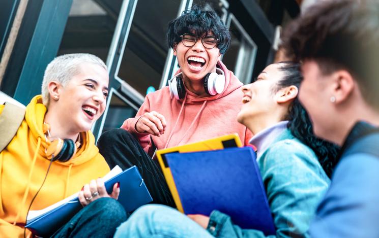 Students having fun together sitting outside