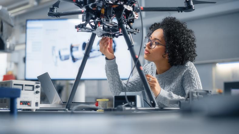 Concentrated Black Female Engineer Writing Code. Developing Software for Modern Drone Control in the Research Center Laboratory