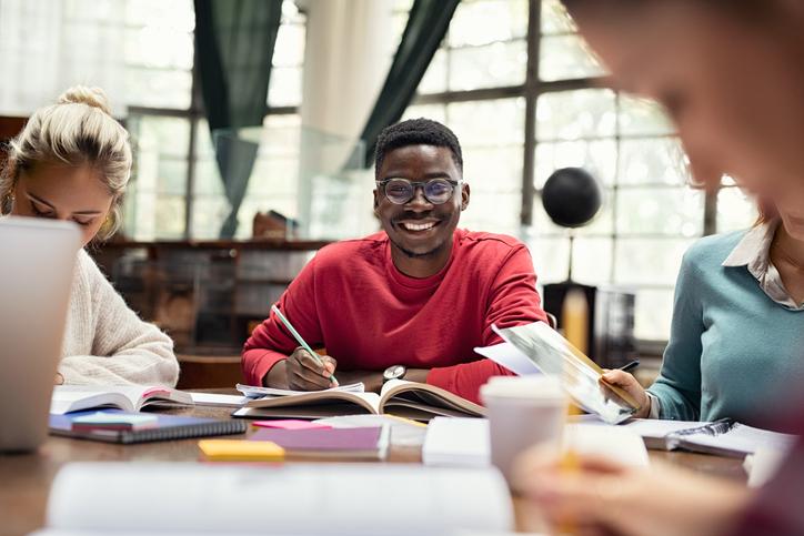 Student in study hall, smiling into the camera