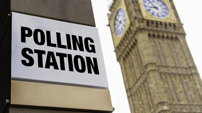 Closeup of polling station sign in front of Westminster/iStock