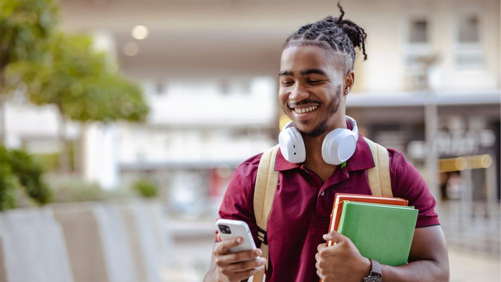 Young student checking his university application online