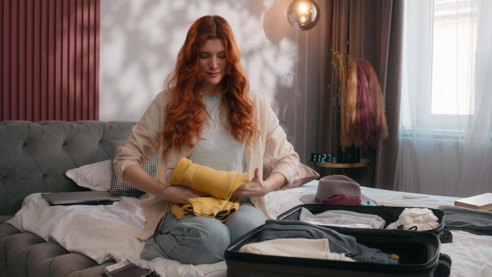 Woman packing suitcase