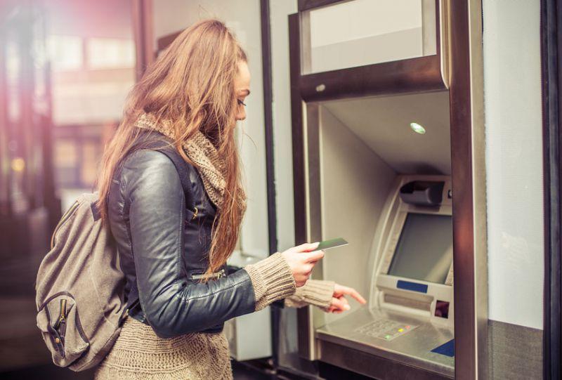 Woman gets money out of cashpoint