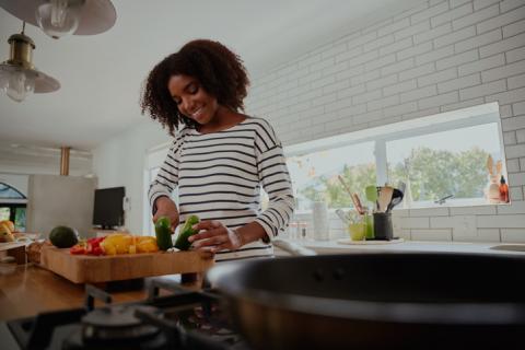 Young woman cooking in her kitchen