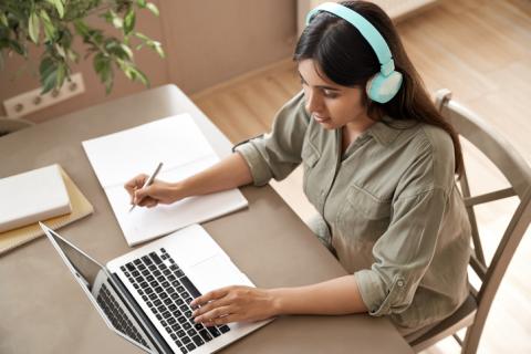 Girl wearing headphones and learning online