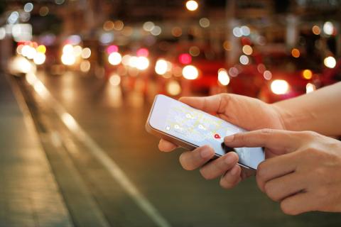 Man checking location on phone at night