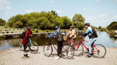 Students on bikes at Exeter quay