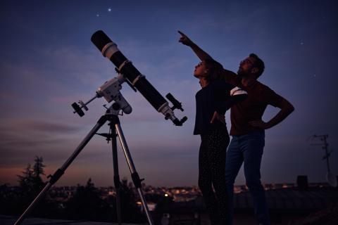 Students looking at the stars with large telescope during the night