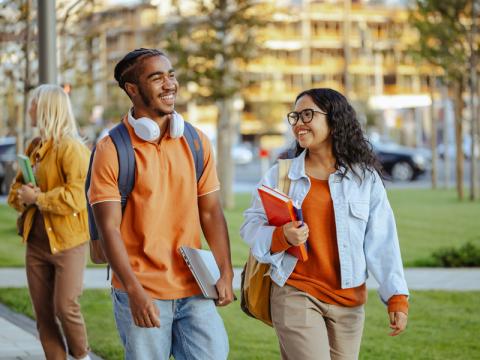 Two students walk together on campus
