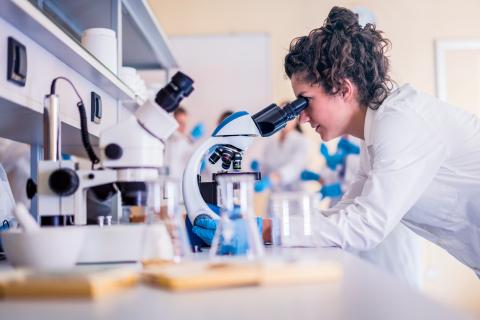 Student lookin in microscope
