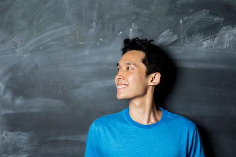 Student in front of blackboard