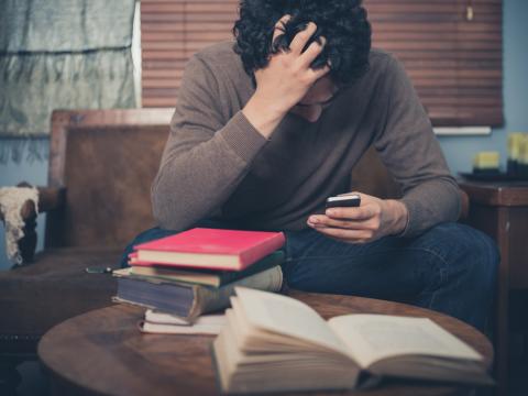 Man revising with books